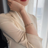 Pulsera doble con charms