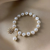 Pulsera con colgante en oro blanco, perla y girasol